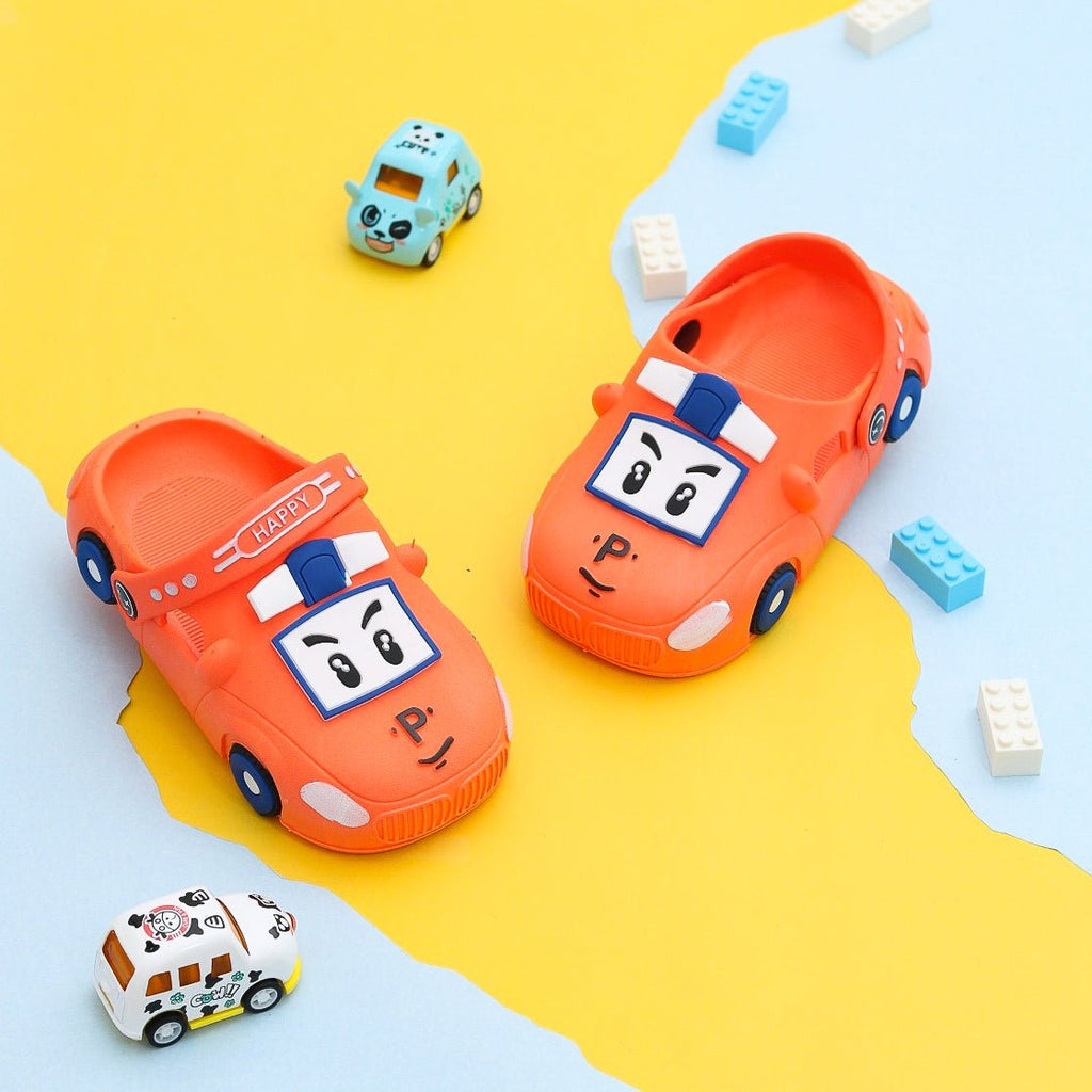 Orange car pattern clogs for boys set against a fun backdrop.