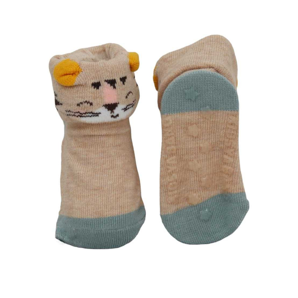 Pair of tan socks with tiger design and teal anti-skid soles for babies.