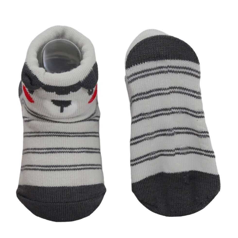 Anti-skid soles on grey striped baby socks with bear face detail