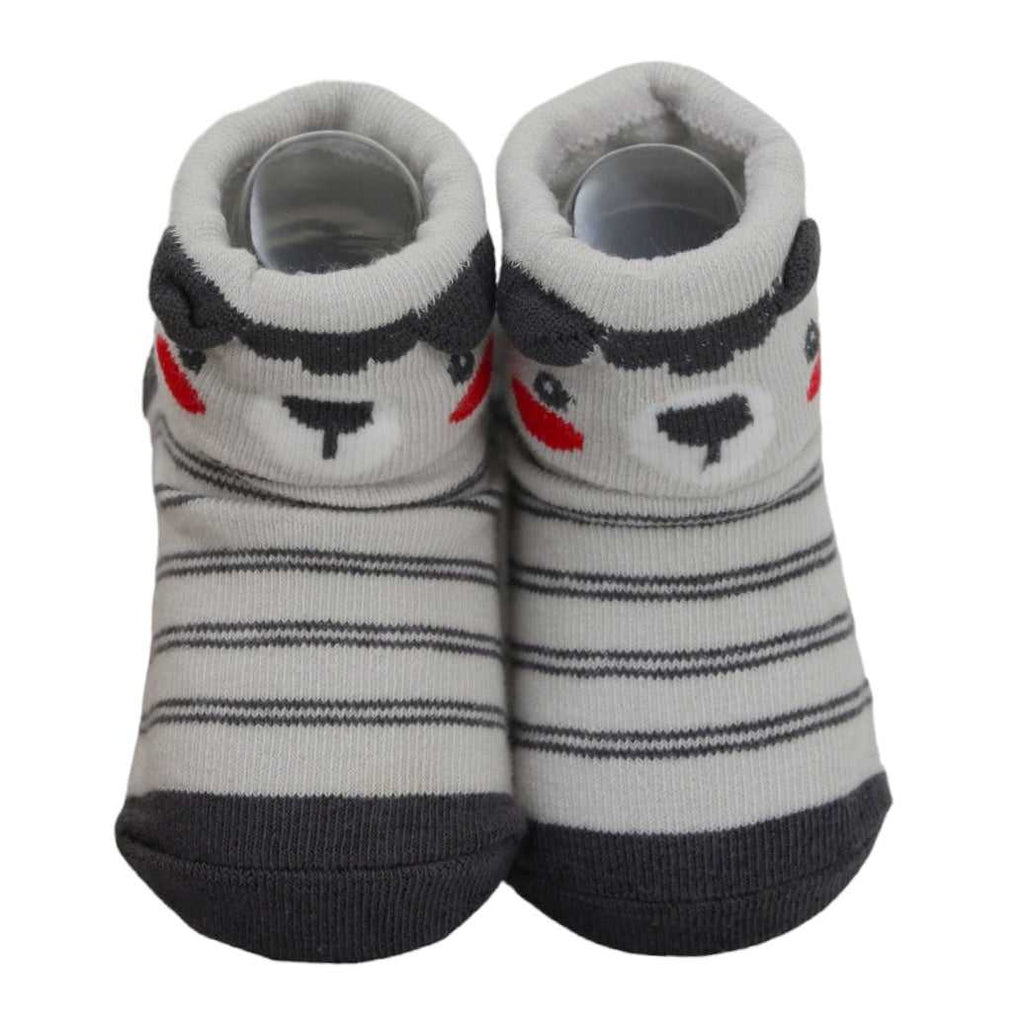 Close-up of grey striped baby socks with bear face and anti-skid soles