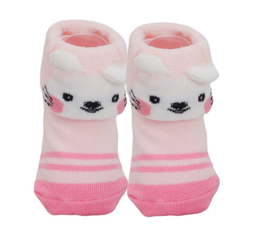 Pink baby girl socks with white stripes and puppy face, with ears on the cuff, isolated on white.