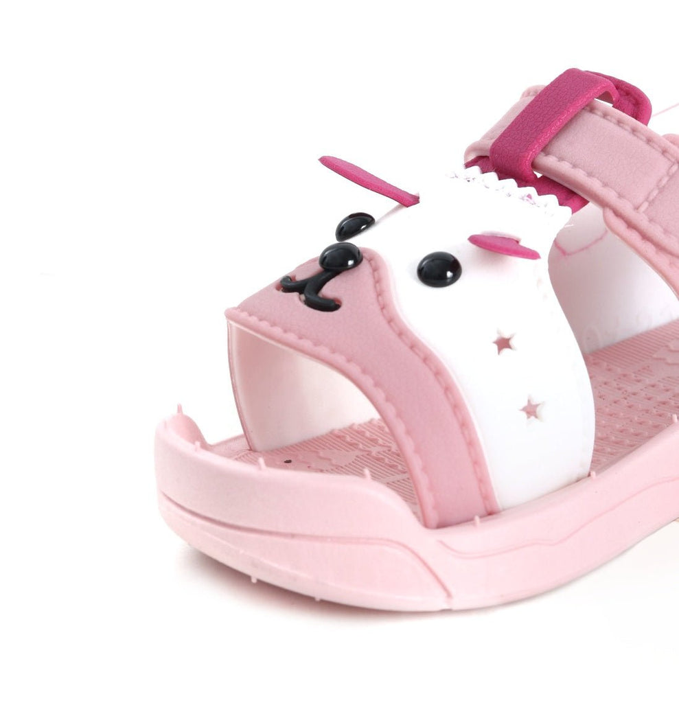 Close-up of pink puppy sandals showing the texture and fun design for kids.