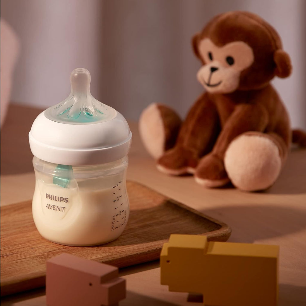 Philips Avent SCY670/01 baby bottle in a serene setting with a plush toy, illustrating a peaceful feeding environment.