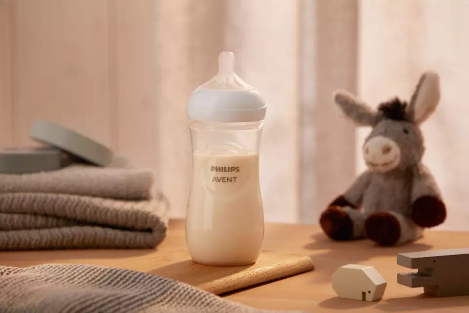 Philips Avent SCY906/01 bottle on a cozy nursery table next to a plush toy