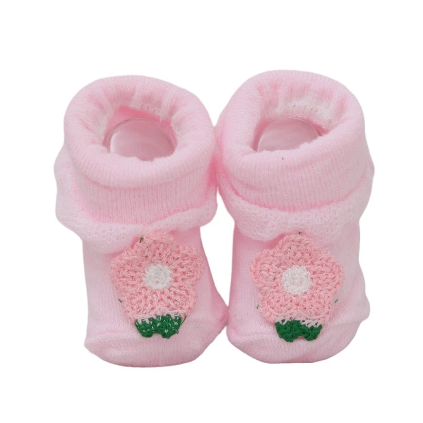 Front view of pink baby socks with flower detailing, perfect for a soft and feminine look.
