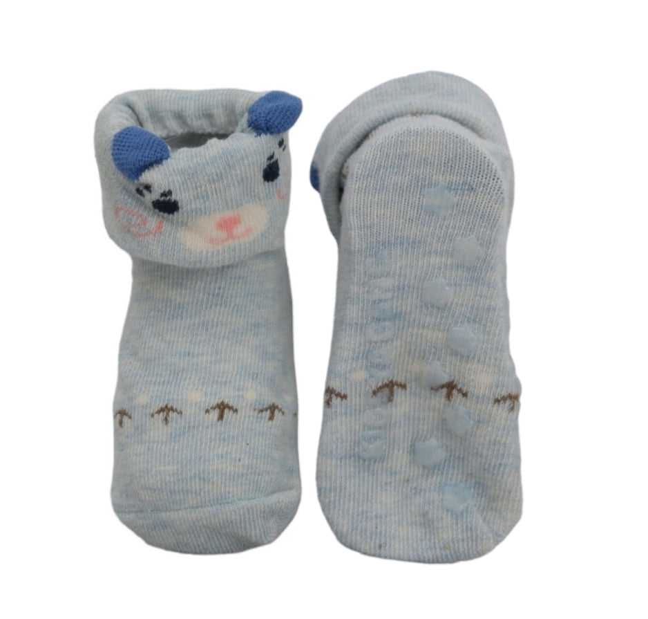 Pair of Yellow Bee's baby blue cow-print socks with anti-skid soles, displayed to show the top and bottom design.