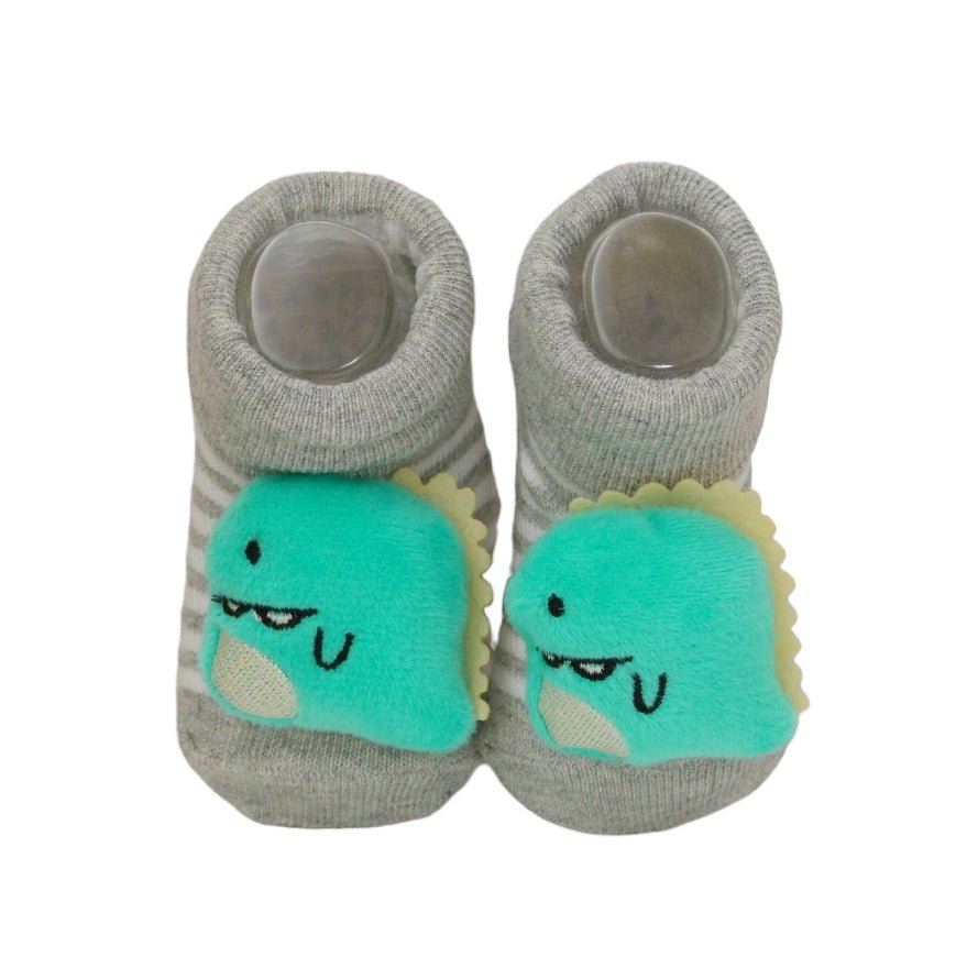 Close-up of baby socks with stuffed bunny and kitty design, highlighting the soft material and cute details.