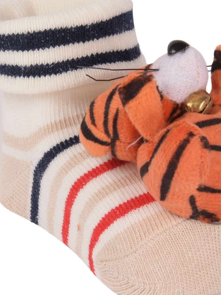 Detailed close-up of child's tiger toy socks showing the stuffed animal and striped design