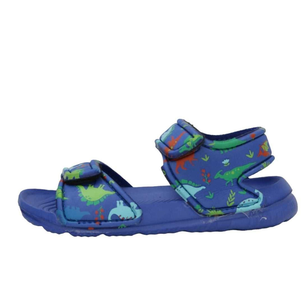 Profile view of blue sandals with all-over dinosaur print, perfect for young adventurers.