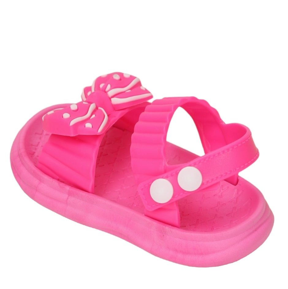 Side view of a dark pink bow detail sandal, showing off its secure fit and adorable design.