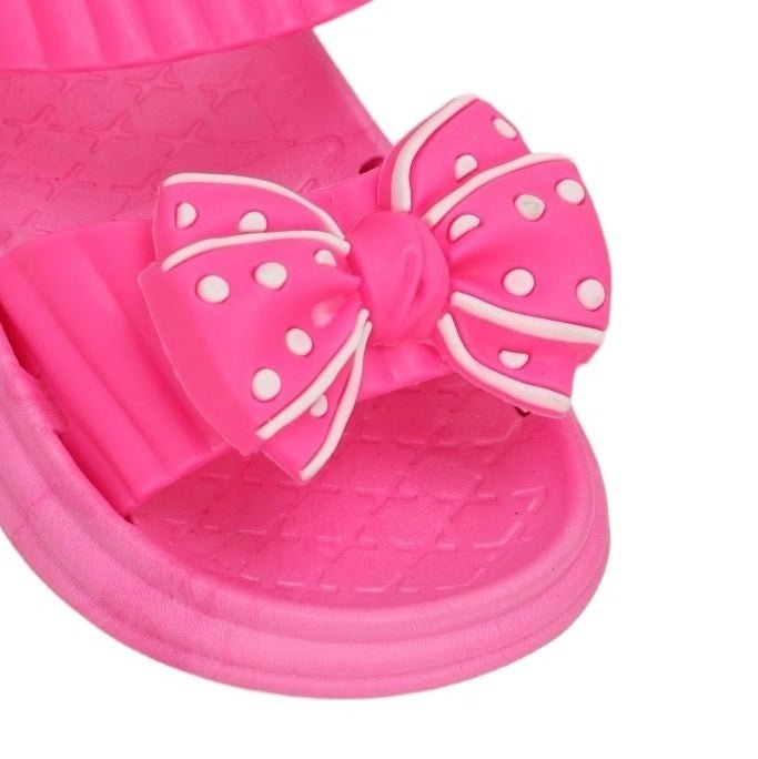 Close-up of the dark pink bow detail on the sandal, showcasing the charming polka dot accents.