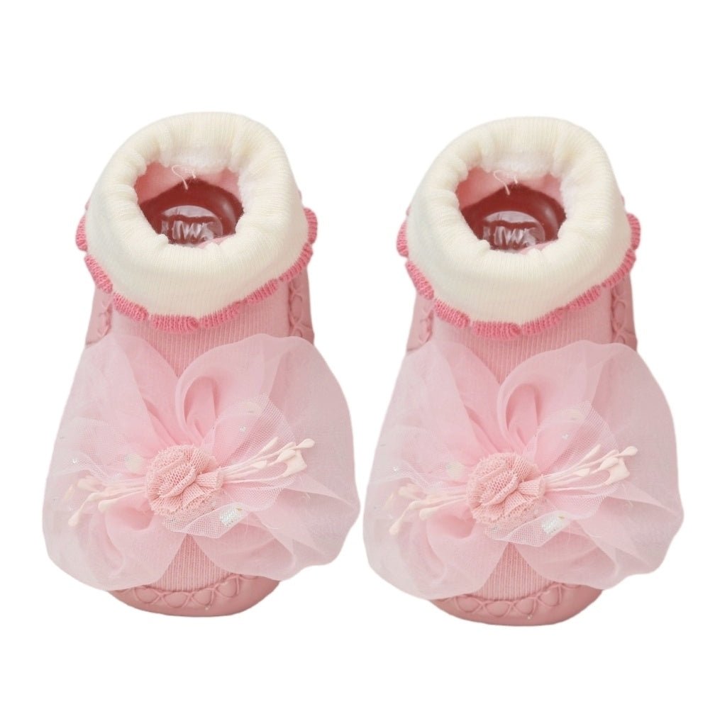 Top view of pink leather baby socks with 3D flower detail and cozy cuffs