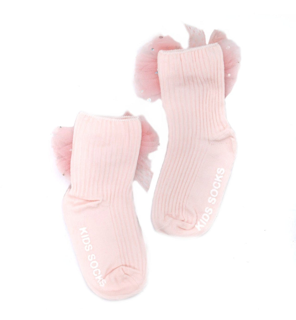 Elegant flat lay of pink kids' socks with delicate tulle bows and ribbed texture.