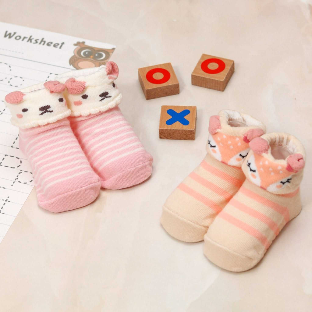 Baby girl's socks set featuring pink puppy and beige deer designs with tic-tac-toe blocks
