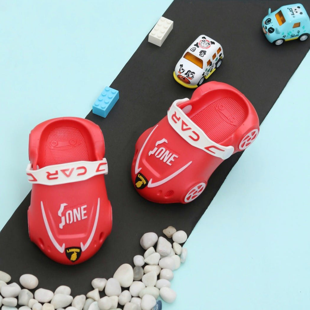 Pair of Red Car-Themed Kids' Clogs on a Playful Racetrack Setting