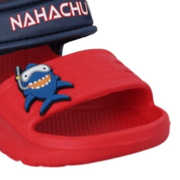 Close-up of Red Shark Sandals' shark emblem on a bright red insole