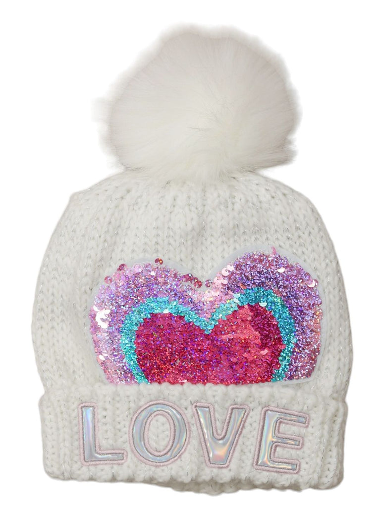 Front view of a white woolen beanie with a sequin heart, fluffy pom-pom, and love inscription.