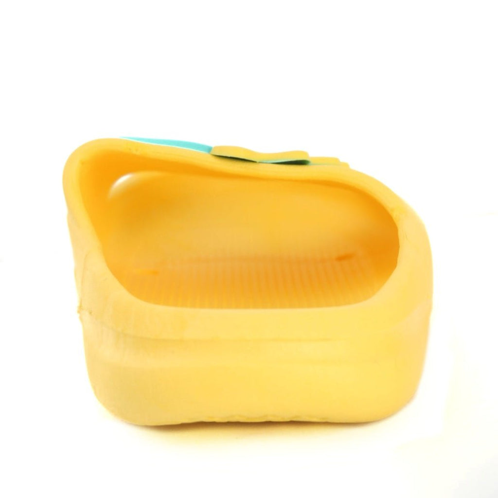 Perspective view of the yellow slide with dino applique, ready for a child's active day