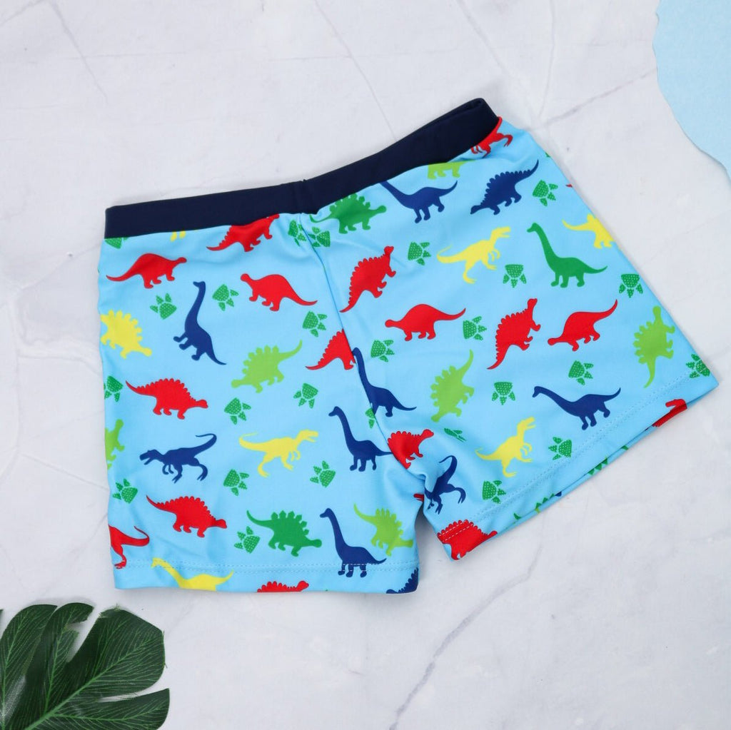 Colorful boys' swim trunks with a dynamic all-over dinosaur print by Yellow Bee, perfect for summer fun.