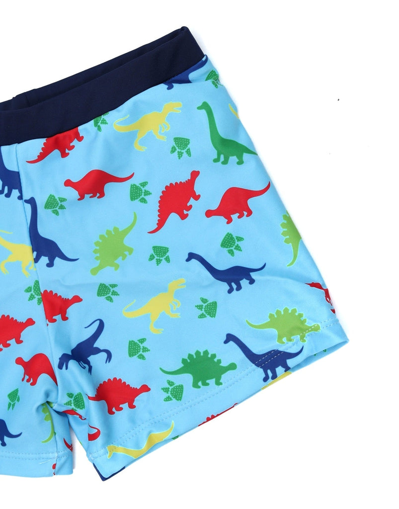 A close-up of Yellow Bee's dinosaur-printed swim trunks, highlighting the vivid colors and playful patterns.