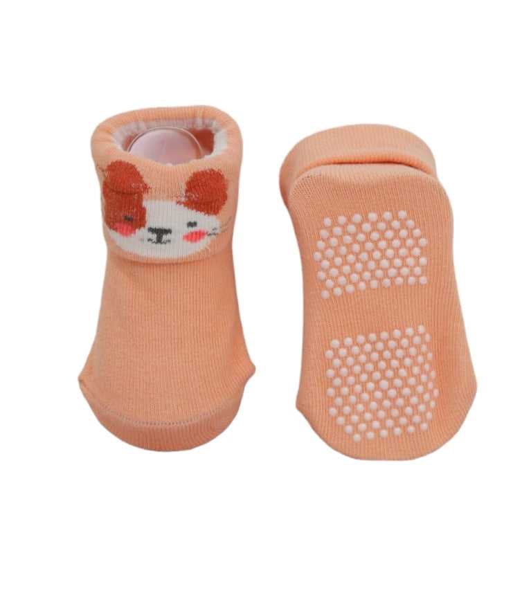 Cozy baby girl socks with lion face applique and non-slip soles.