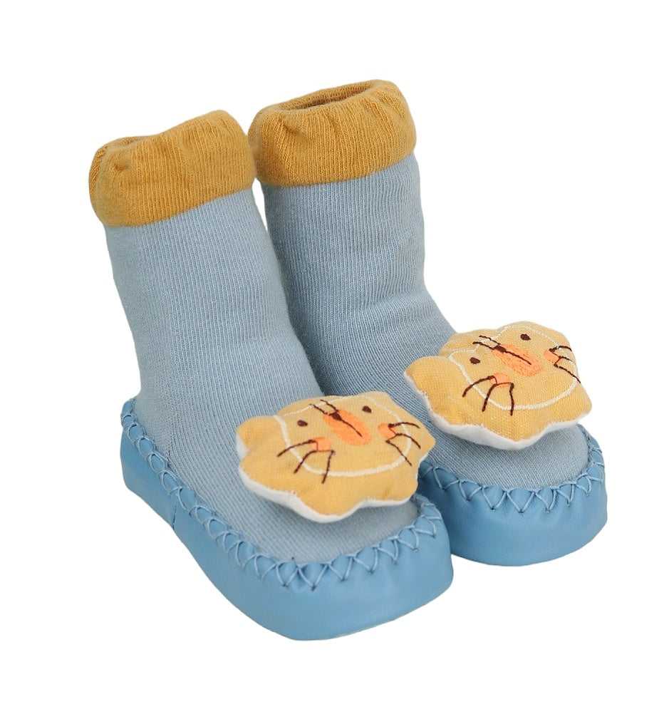 Pair of baby boy's blue leather socks with cute lion face decoration packaged in a clear box