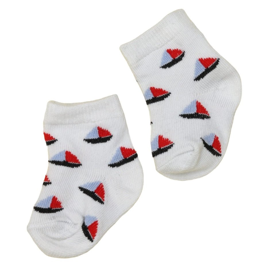 Close-up of white baby boy socks with red and blue boat pattern