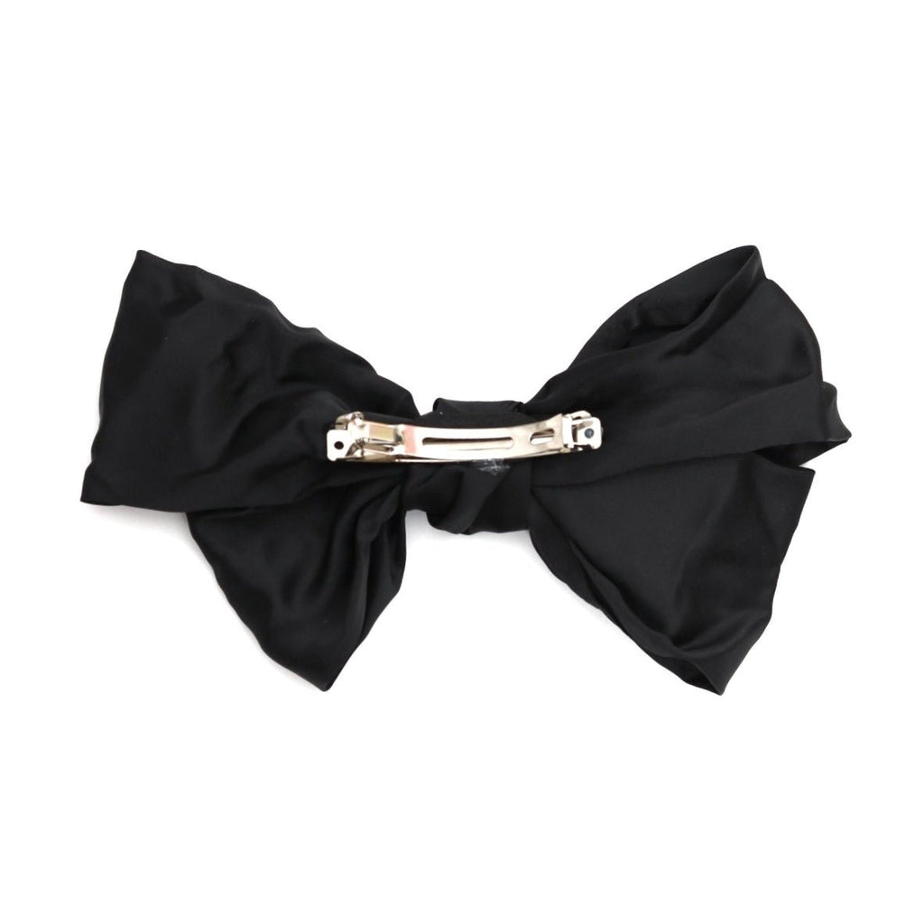 Back view of a black bow hair clip for girls, showcasing the clasp detail by Yellow Bee.