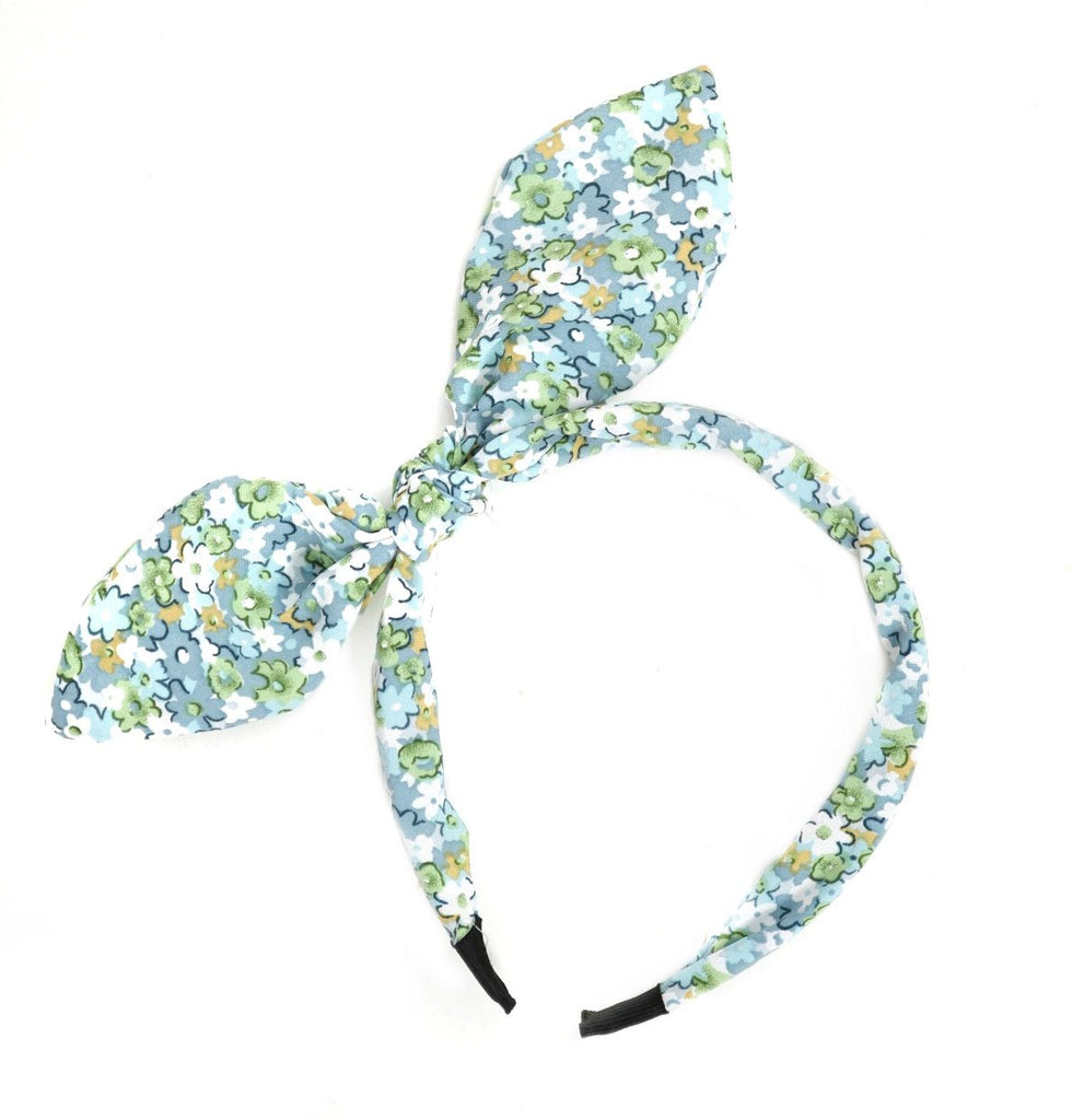 Floral patterned blue hair band from Yellow Bee, adding a pop of pattern to a girl's hairstyle.
