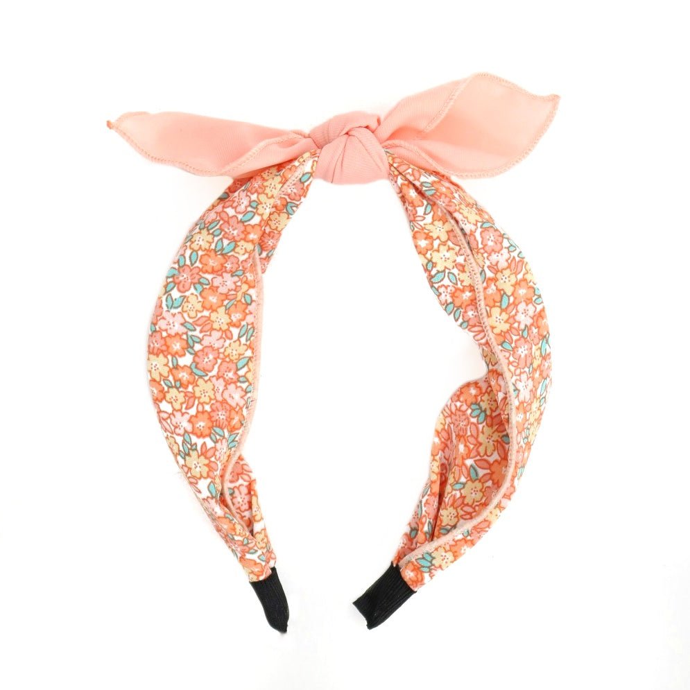 Side view of Yellow Bee's peach hair bands showcasing the charming bow design.