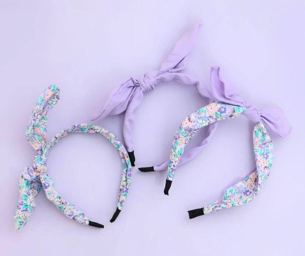 Overview of Yellow Bee's set of 3 purple hair bands for girls with solid and floral designs.