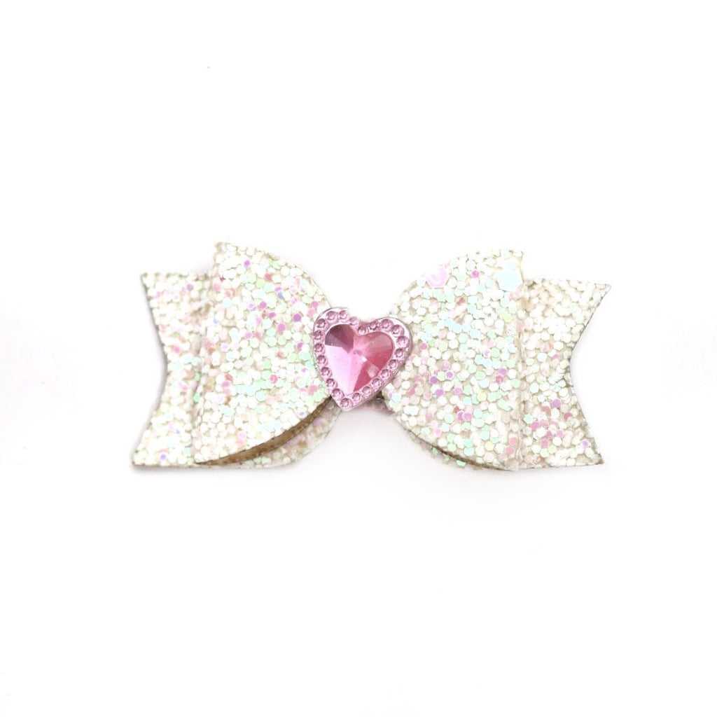 Sparkling pink bow hair clip with heart detail from Yellow Bee's accessory range for girls.