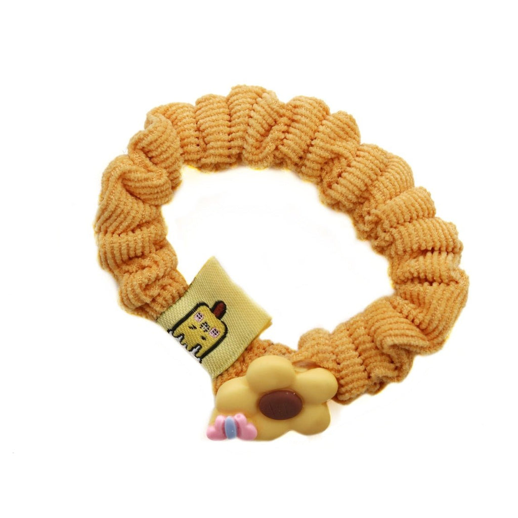 Yellow rubber band featuring a playful dog charm from Yellow Bee's accessory collection.