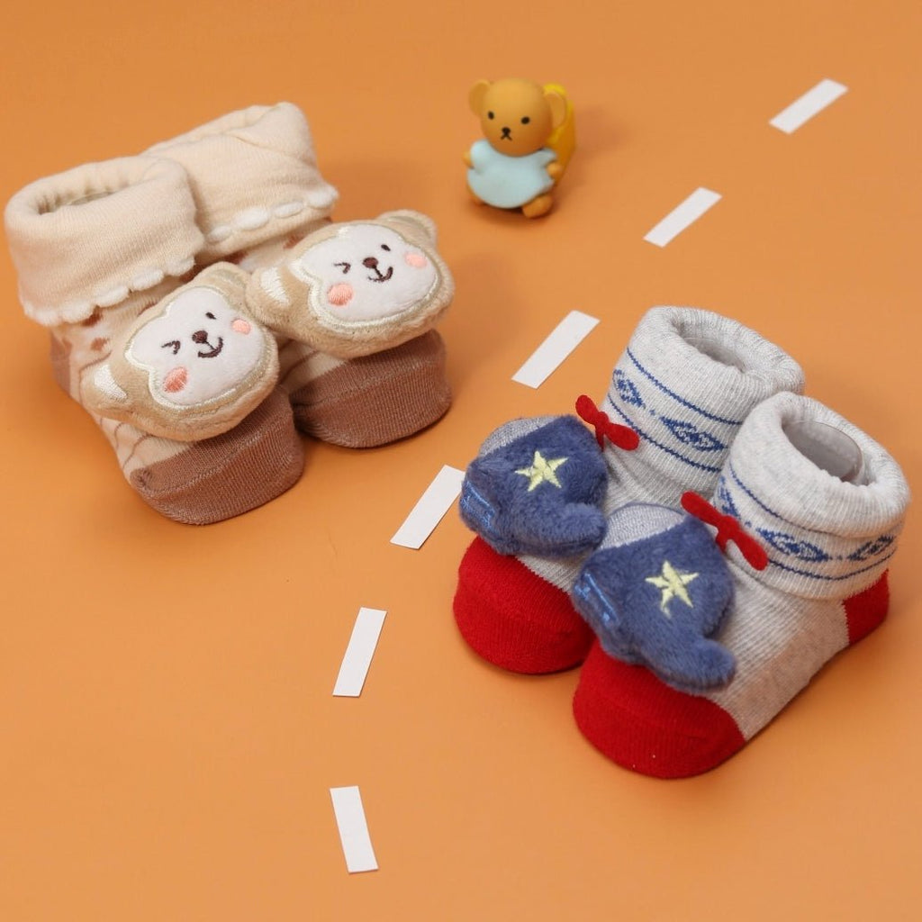 Cute monkey plush toy socks set for babies with a playful helicopter theme.