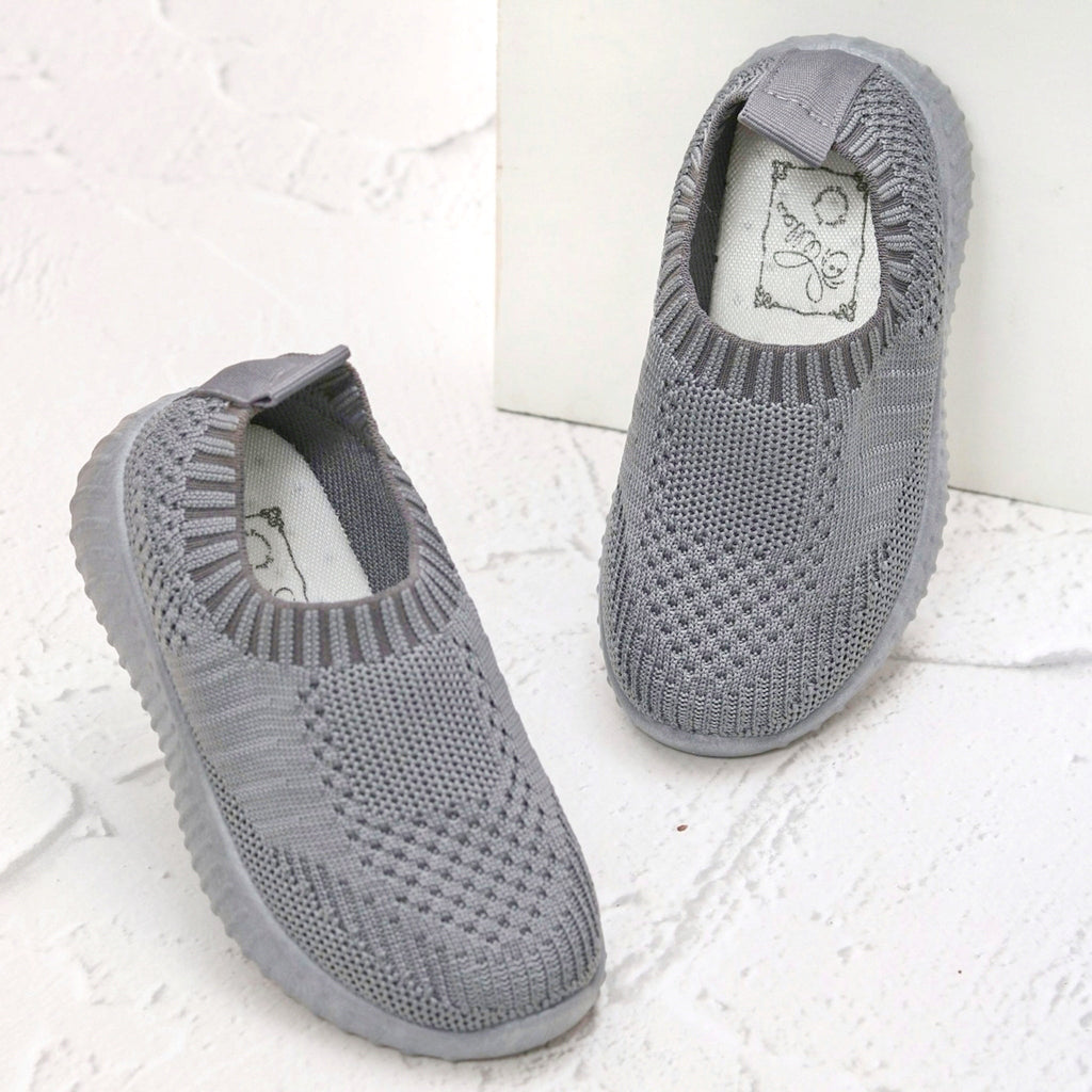 Pair of grey knit slip-on sneakers for kids with cushioned comfort and style by Yellow Bee