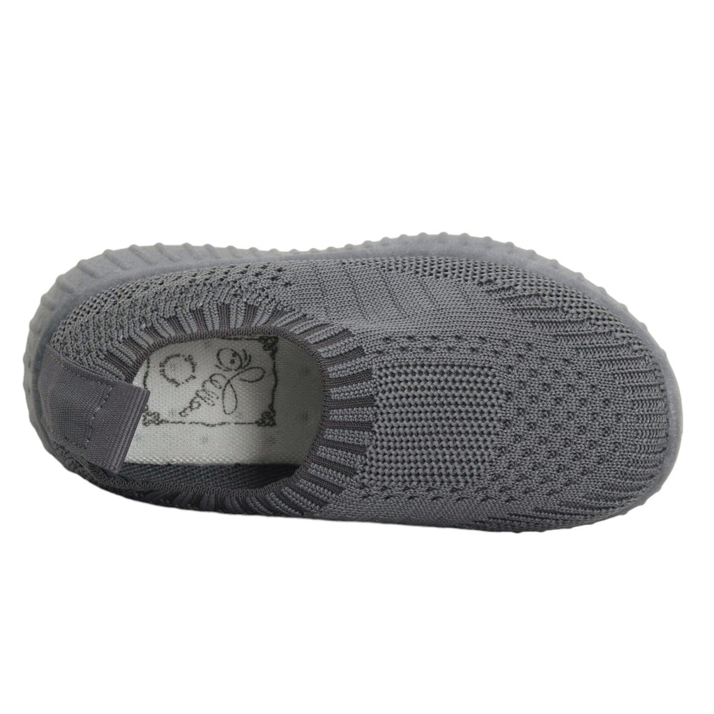 op-down view of grey slip-on sneakers, emphasizing the breathable knit and easy-wearing style