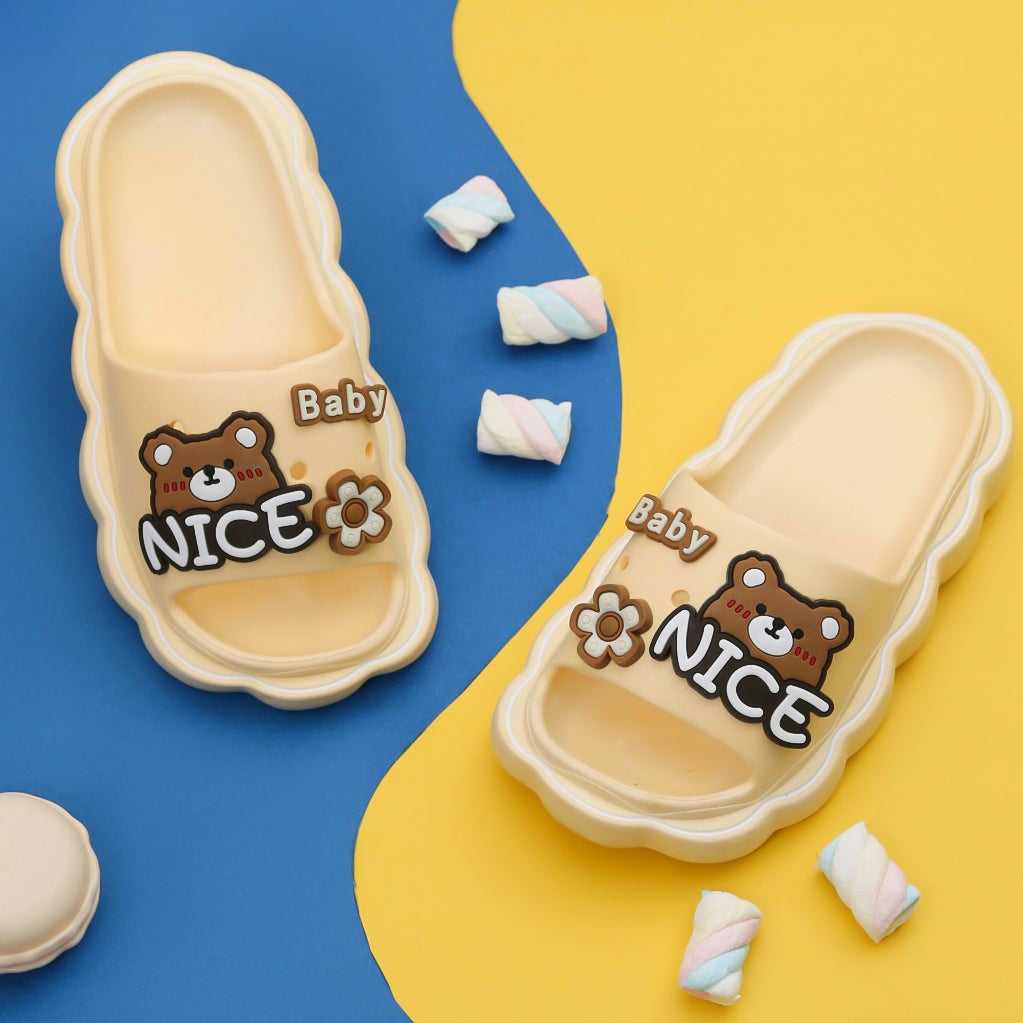 Pair of Snuggly Baby Bear Beige Slides with Playful Toys on a Warm Background