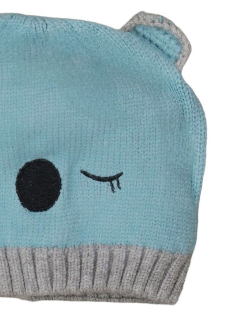 Close-up of boys' white bear beanie showing detailed stitching and ears
