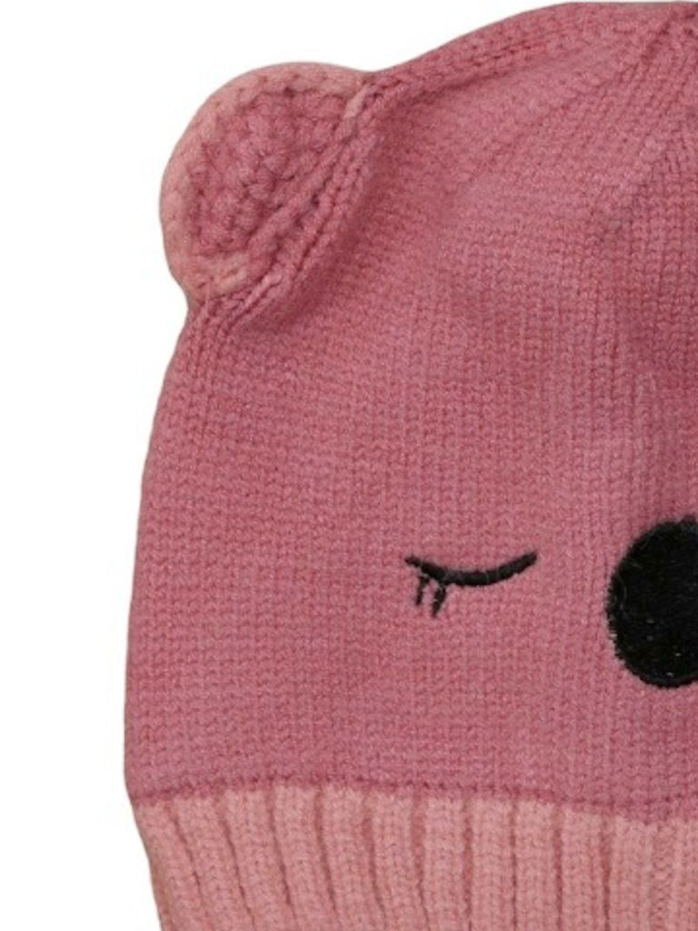 Close-up of the teddy ear detail on a dark pink knitted beanie for girls.
