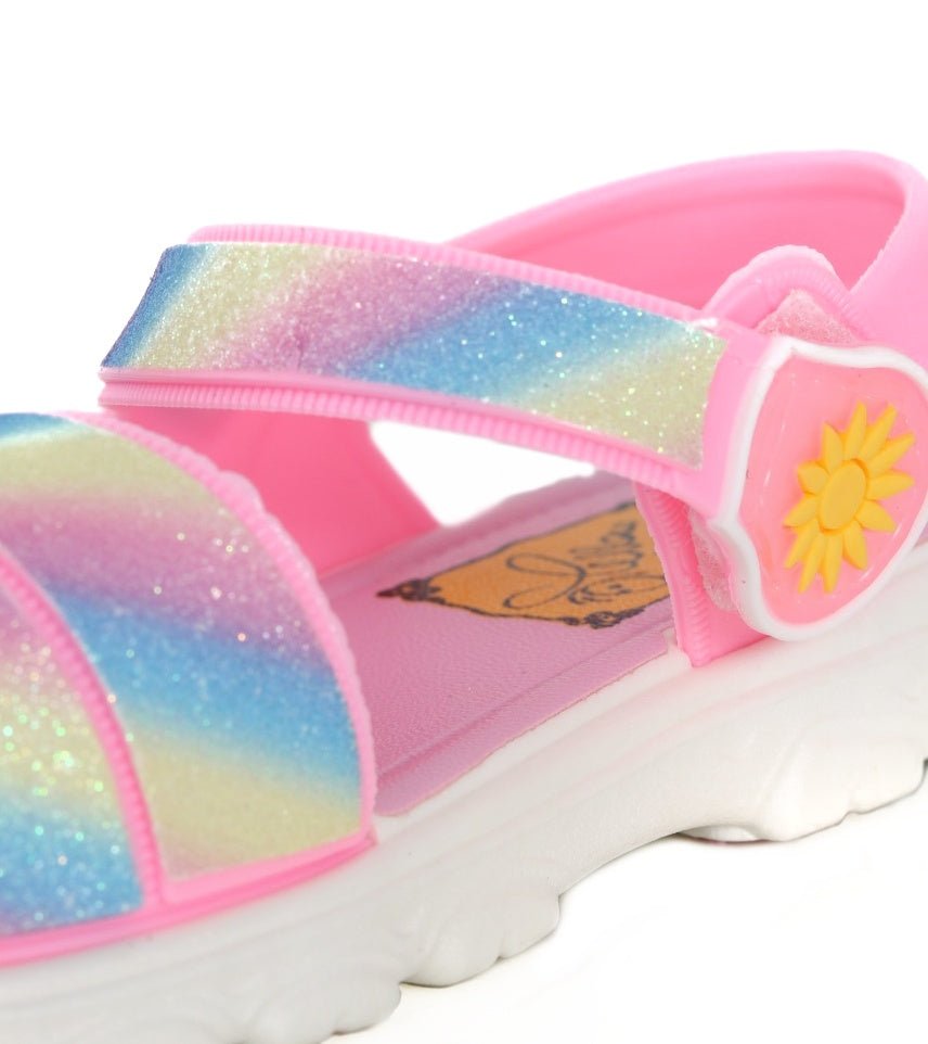 Close-up of the Rainbow Glitter Sandals' strap with a cute bear emblem and sparkly finish