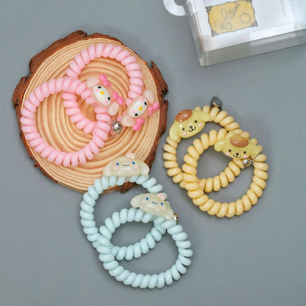  Display of Yellow Bee's spiral rubber bands with magnets, styled as bracelets, highlighting their versatility and charm.