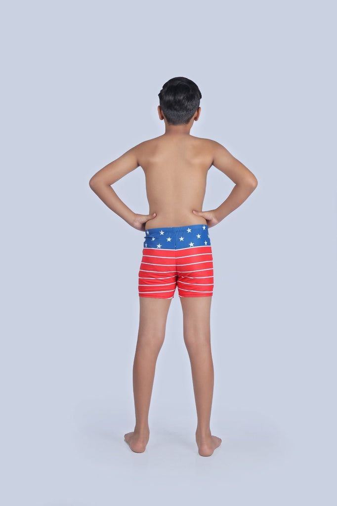 Back view of boy wearing Yellow Bee's patriotic swim shorts, ready for Independence Day celebrations.