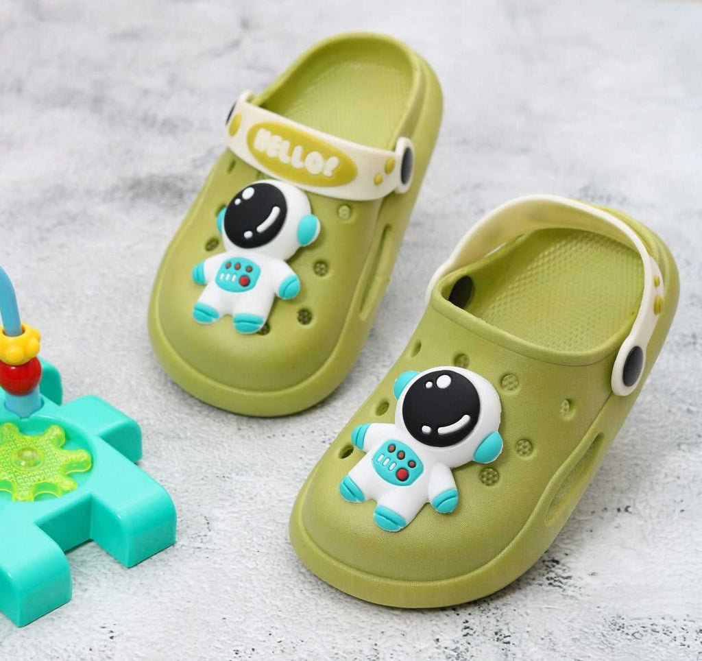 Child's green astronaut-themed clogs with fun character design on a playful background