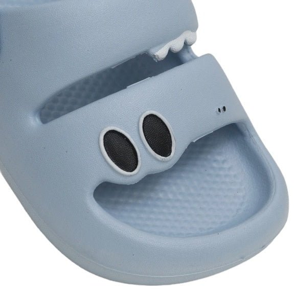 Close-up of the Stompy Blue Dino Sandal's front, emphasizing the playful dino eyes.