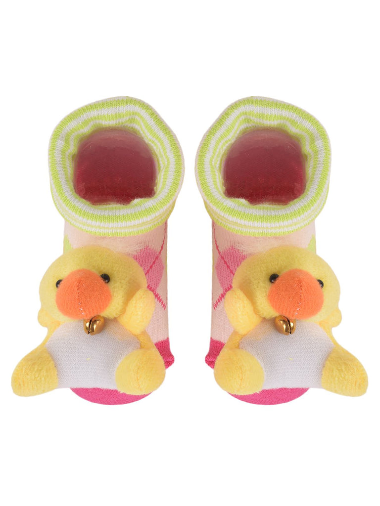 Cute baby socks with strawberry design and plush duck toy on a blue background.