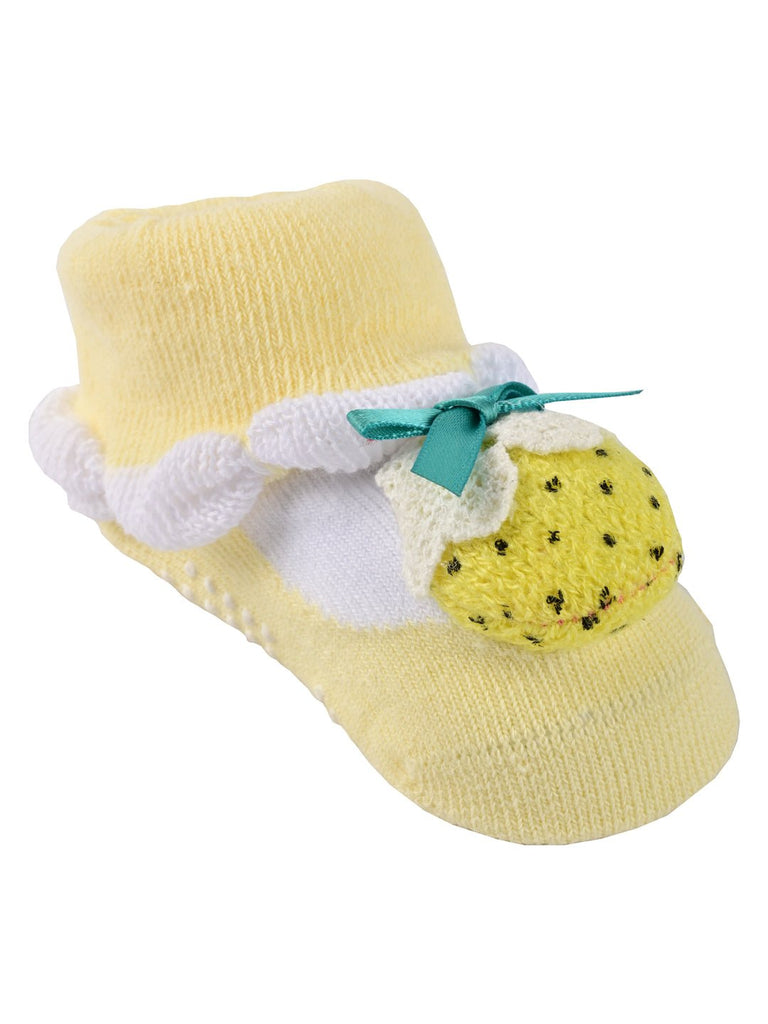 Side angle view of yellow stuffed toy socks with strawberry design for children