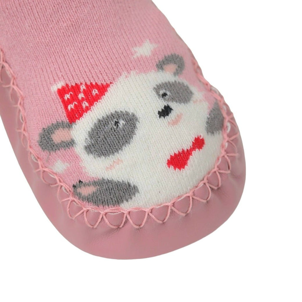 Detailed close-up of the panda face print on pink leather socks for baby girls