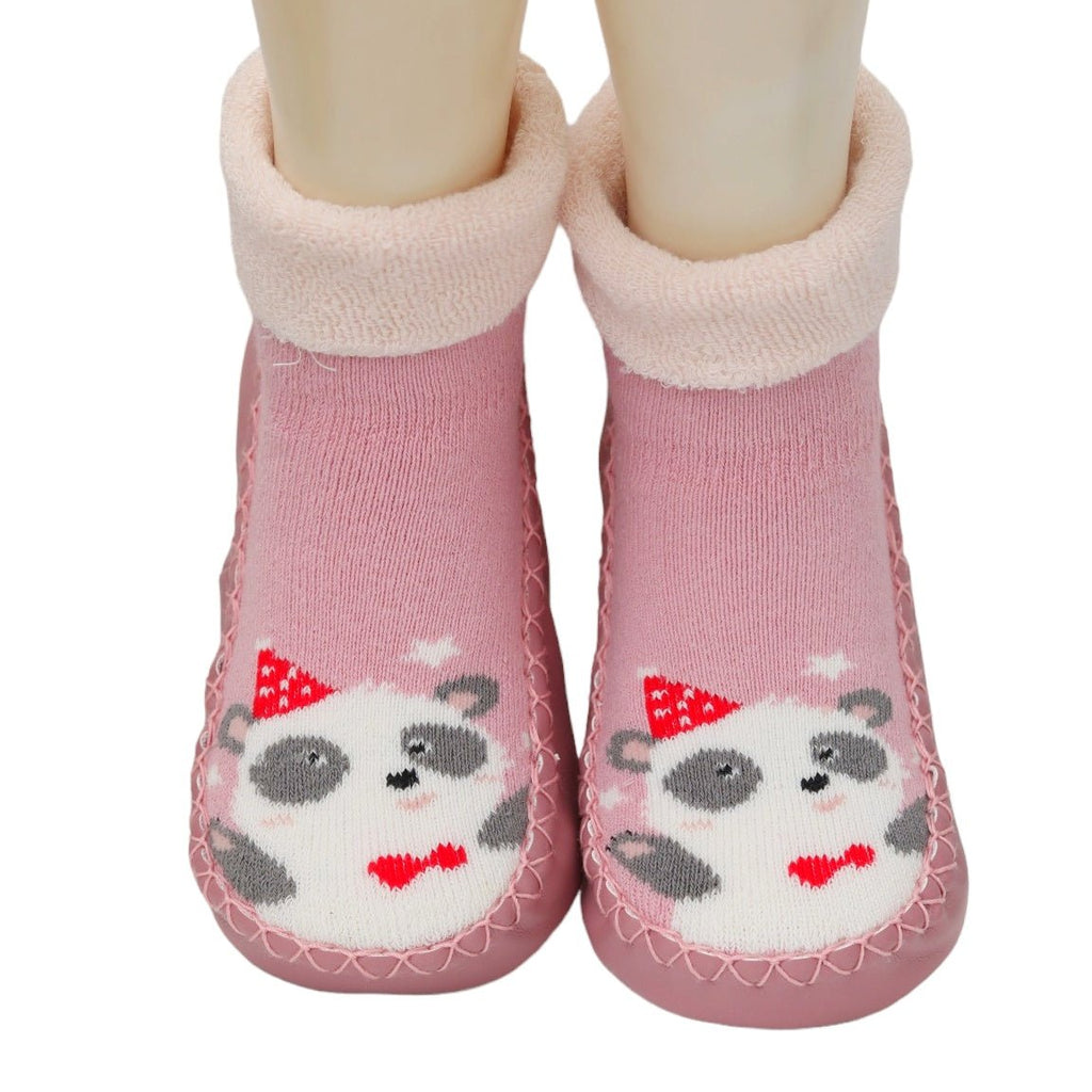 Close-up of baby girl's feet in pink panda print socks with soft leather soles