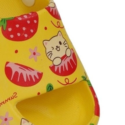 Detailed close-up of the toe box on yellow children's sandals featuring a strawberry and cat theme.