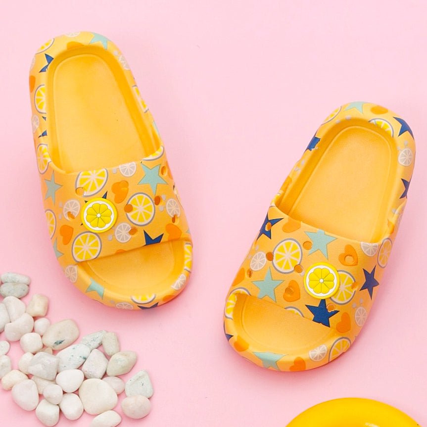 Bright Yellow Citric Fruit and Star Print Slides Against a Playful Pink Background